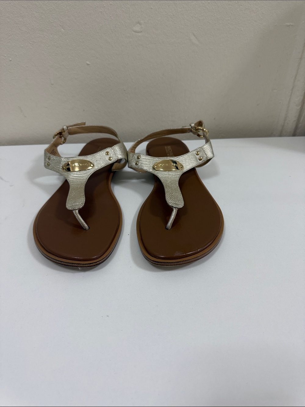 MICHAEL Michael Kors Gold Metallic T‑Strap Sandals with Brown Footbed